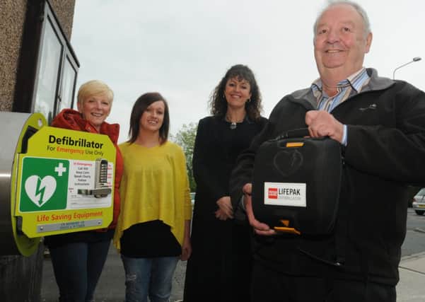 Cheryl O'Connor, Nicola Gee, Claire McEnery and Stuart Holbrook with one of the three new defibrillators in Read and Simonstone.