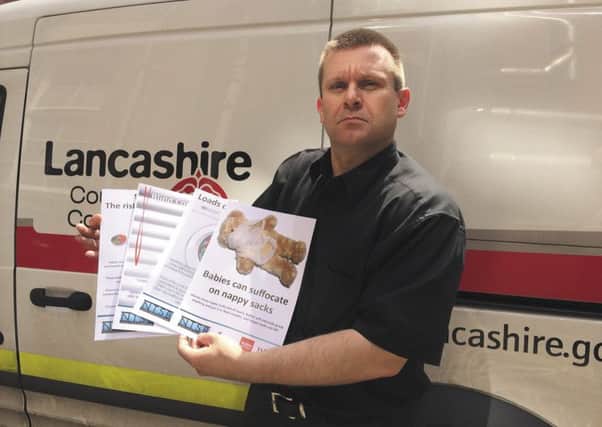 Steve Brimble, of Lancashire Trading Standards, with the new posters.