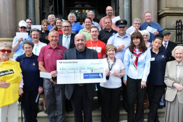 Jeff Brown presents £10,000-worth of cheques to local charities after  last year's Pennine Lancashire 10K organised by Jane Tomlinson's Run For All