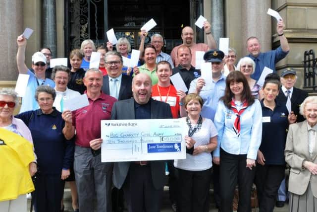 Jeff Brown presents £10,000-worth of cheques to local charities after  last year's Pennine Lancashire 10K organised by Jane Tomlinson's Run For All