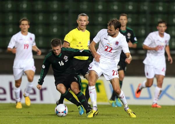 Tough opposition: Oliver Norwood battle for possession in Northern Irelands game against Luxembourg.