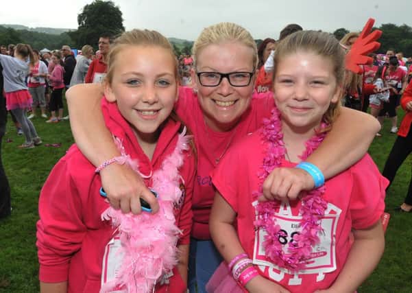 RACE FOR LIFE: From the left, Katie Harrow (12), Lisa Doyle and Ellie Doyle (11) take part in the Cancer Research Race for Life at Towneley Park, Burnley.