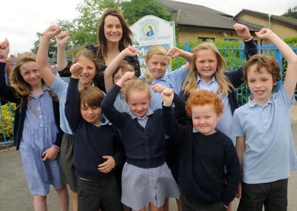 Headteacher Claire Halstead with pupils at St Mary's Primary school who received good Ofstead results