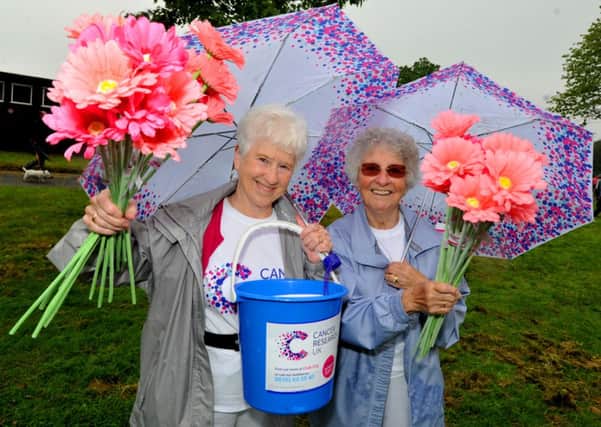 Fund-raising volunteers Ellen Watson and Pat Duckett, right, as ladies take part in the annual Cancer Research UK Race for Life at Towneley Park, Burnley.
