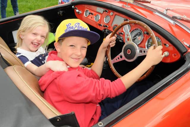 Burnley Classic Vehicle Show at Towneley Park, Burnley
Tyler Lusty and Eliena Lusty get to sit in a 1957 MG A. Photo: David Hurst
