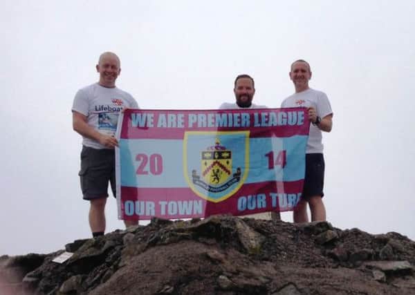 Dave Hursthouse, Paul Cunningham and Dave McDonald flying the Burnley flag on top of Ben Nevis