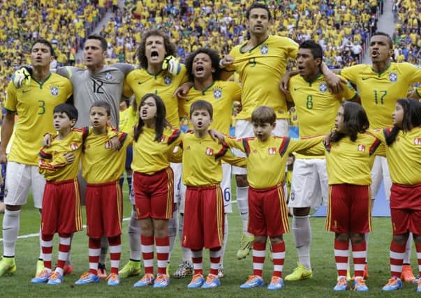Host nation: Brazil players belt out their national anthem