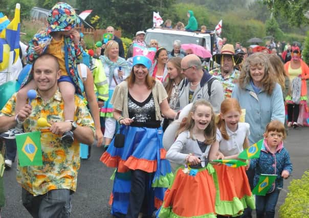 The Fence United World Cup themed procession makes its way through the village with walkers in fancy dress.