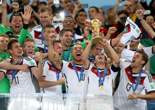 Germany's Philipp Lahm lifts the World Cup trophy as he celebrates winning the World Cup with team-mates after the FIFA World Cup Final at the Estadio do Maracana, Rio de Janerio, Brazil