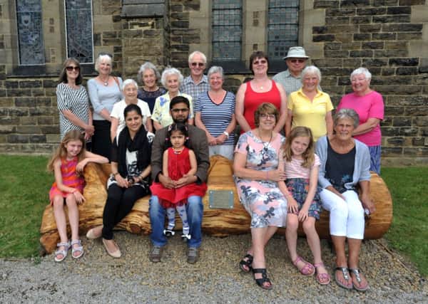 A local shop owner, Zaid Choksi and family, officially present a unique bench, carved from 100-year-old oak tree, to the Read Mother's Union, place in the grounds of Read St John's church.