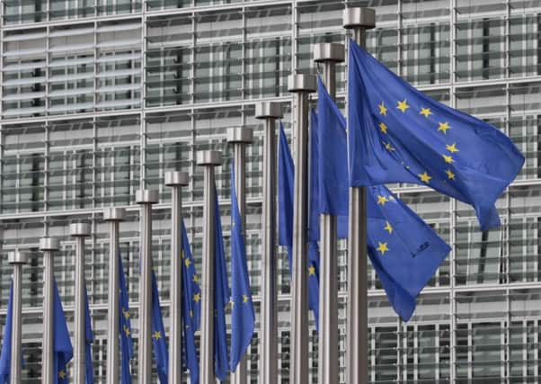 EU flags fly at the European Commission headquarters in Brussels. .   (AP Photo/Yves Logghe, File)