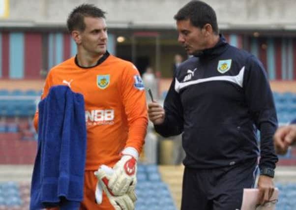 Keepers union: Tom Heaton in discussion with goalkeeping coach Billy Mercer on Tuesday night