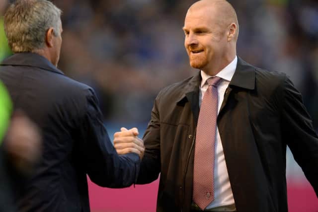 Chelsea manager Jose Mourinho (left) and Burnley manager Sean Dyche (right) during the Barclays Premier League match at Turf Moor, Burnley. PRESS ASSOCIATION Photo. Picture date: Monday August 18, 2014. See PA story SOCCER Burnley. Photo credit should read: Martin Rickett/PA Wire. RESTRICTIONS: Editorial use only. Maximum 45 images during a match. No video emulation or promotion as 'live'. No use in games, competitions, merchandise, betting or single club/player services. No use with unofficial audio, video, data, fixtures or club/league logos.