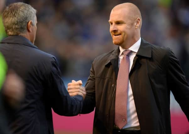 Chelsea manager Jose Mourinho (left) and Burnley manager Sean Dyche (right) during the Barclays Premier League match at Turf Moor, Burnley. PRESS ASSOCIATION Photo. Picture date: Monday August 18, 2014. See PA story SOCCER Burnley. Photo credit should read: Martin Rickett/PA Wire. RESTRICTIONS: Editorial use only. Maximum 45 images during a match. No video emulation or promotion as 'live'. No use in games, competitions, merchandise, betting or single club/player services. No use with unofficial audio, video, data, fixtures or club/league logos.