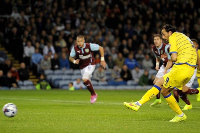 Sheffield Wednesday's Atdhe Nuhiu scores his teams first goal against Burnley, during the Capital One Cup Second Round match at Turf Moor, Burnley. PRESS ASSOCIATION Photo. Picture date: Tuesday August 26, 2014. See PA story SOCCER Burnley. Photo credit should read: Martin Rickett/PA Wire. RESTRICTIONS: Editorial use only. Maximum 45 images during a match. No video emulation or promotion as 'live'. No use in games, competitions, merchandise, betting or single club/player services. No use with unofficial audio, video, data, fixtures or club/league logos.