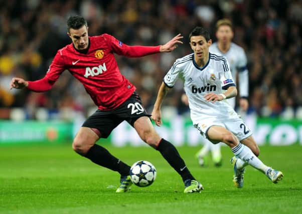 Turf debut?: Angel Di Maria, right, in action for Real Madrid against Robin van Persie, his new team mate at Manchester United