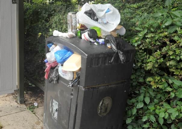 An overflowing rubbish bin