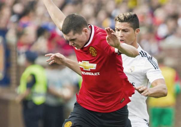 Michael Keane in action for Man Utd against Real Madrid's Ronaldo