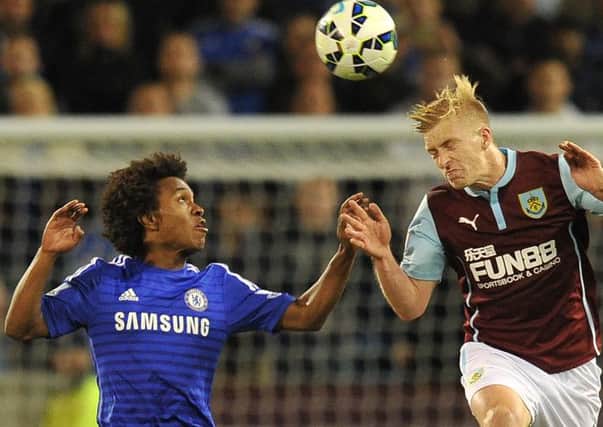 Valuable experience: Defender Ben Mee battles with Chelseas Willian on his Premier League debut