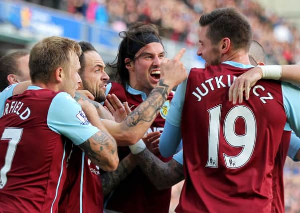 Burnley's Danny Ings (left centre) celebrates with his team-mates after scoring his side's first goal during the Barclays Premier League match at Turf Moor, Burnley. PRESS ASSOCIATION Photo. Picture date: Sunday October 26, 2014. See PA story SOCCER Burnley. Photo credit should read: Lynne Cameron/PA Wire. Editorial use only. Maximum 45 images during a match. No video emulation or promotion as 'live'. No use in games, competitions, merchandise, betting or single club/player services. No use with unofficial audio, video, data, fixtures or club/league logos.