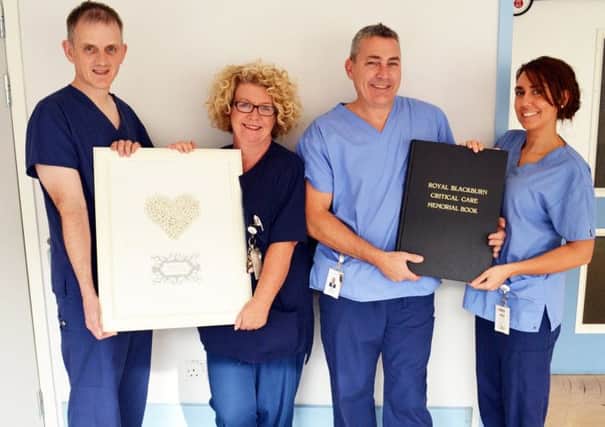TIME TO REMEMBER: Critical Care Sister Linda Gregson (second left) and colleagues pictured with the Critical Care Memorial Book of Condolence
