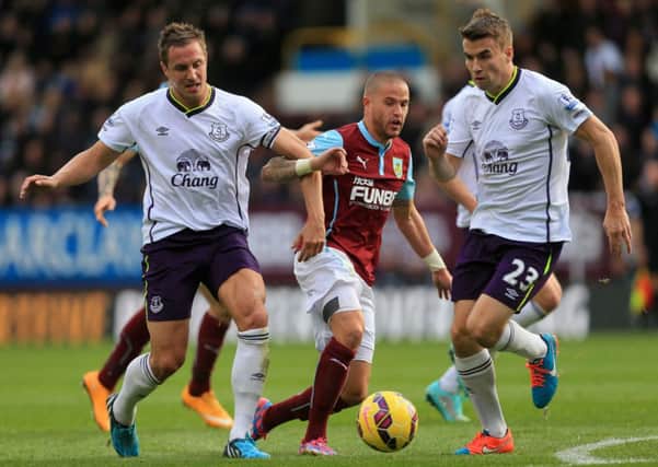 Michael Kightly tries to escape the attentions of Phil Jagielka (left) and Seamus Coleman (right)