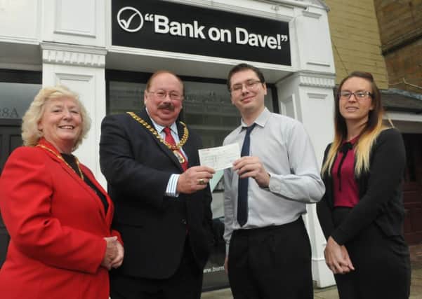 The Mayor and Mayoress of Burnley, Coun. Andy Tatchell and Mrs Lorna Tatchell are presented with a cheque for £400 from Burnley's Bank of Dave branch manager Chris Woods and assistant branch manager Rachel Cowan for the Burnley's Got Talent competition.
