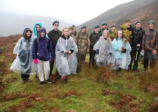 This photo shows the Clitheroe Youth Forum members together with the Air Cadets about to plant the saplings.