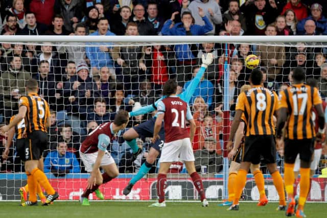 Burnley's Ashley Barnes (second left) scores a header during the Barclays Premier League match at Turf Moor, Burnley. PRESS ASSOCIATION Photo. Picture date: Saturday November 8, 2014. See PA story SOCCER Burnley. Photo credit should read Richard Sellers/PA Wire. Editorial use only. Maximum 45 images during a match. No video emulation or promotion as 'live'. No use in games, competitions, merchandise, betting or single club/player services. No use with unofficial audio, video, data, fixtures or club/league logos.