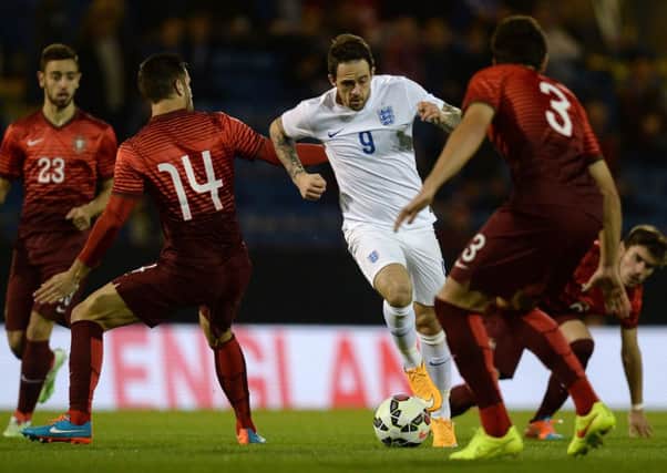 England U21's Danny Ings battles for the ball with Portugal U21's Frederico Venancio during the International friendly at Turf Moor, Burnley. PRESS ASSOCIATION Photo. Picture date: Thursday November 13, 2014. See PA story SOCCER England U21. Photo credit should read: Martin Rickett/PA Wire. RESTRICTIONS: Use subject to FA restrictions. Editorial use only. Commercial use only with prior written consent of the FA. No editing except cropping. Call +44 (0)1158 447447 or see www.paphotos.com/info/ for full restrictions and further information