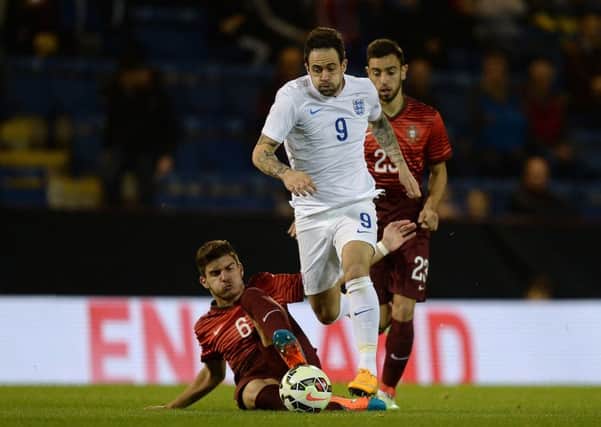 Danny Ings battles for the ball with Portugal U21's Ruben Neves
