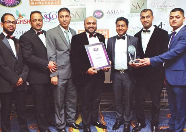 Staff from the Usha collecting the award for Best South Asian Restaurant  in the North-West. (s)