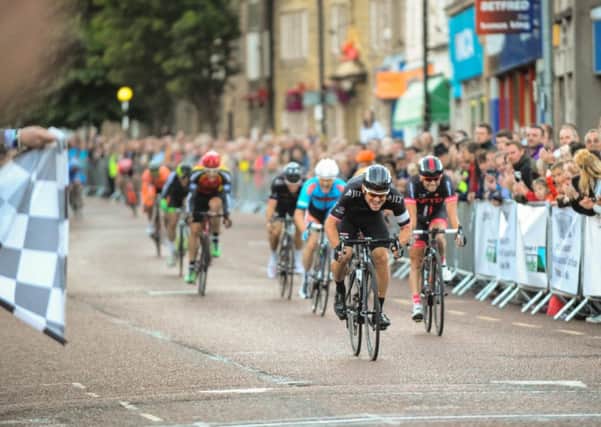 Professional and amateur cyclists race through Colne for the annual Colne Grand Prix.