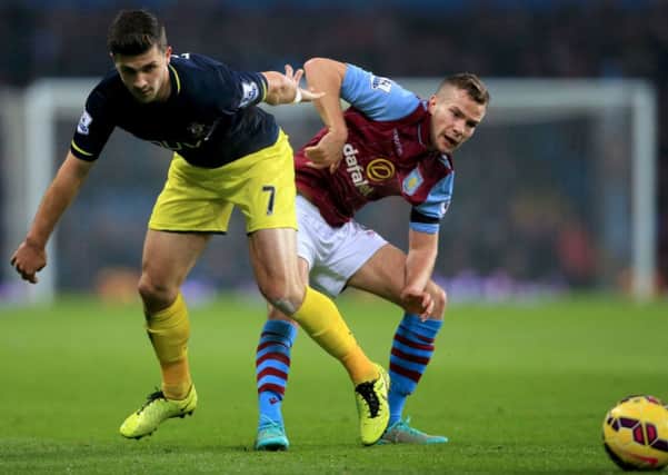 Southampton's Shane Long (left) and Aston Villa's Tom Cleverley battle for the ball during the Barclays Premier League match at Villa Park, Birmingham. PRESS ASSOCIATION Photo. Picture date: Monday November 24, 2014. See PA story SOCCER Villa. Photo credit should read Nick Potts/PA Wire. Editorial use only. Maximum 45 images during a match. No video emulation or promotion as 'live'. No use in games, competitions, merchandise, betting or single club/player services. No use with unofficial audio, video, data, fixtures or club/league logos.