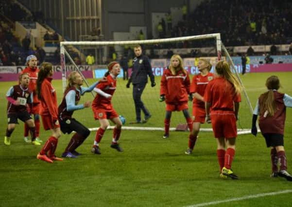 Turf treat: Burnley FC Ladies Under 12s and Under 13s enjoy their half-time appearance at Turf Moor at the Newcastle United game last Tuesday