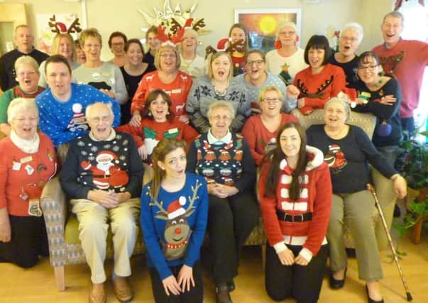 PARTY SPIRIT: Staff, volunteers and day therapy patients at Pendleside Hospice at their Christmas Jumper Day