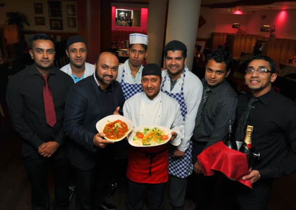 Head chef  Ibby Ali, third left, with staff at the Usha restaurant, Burnley.