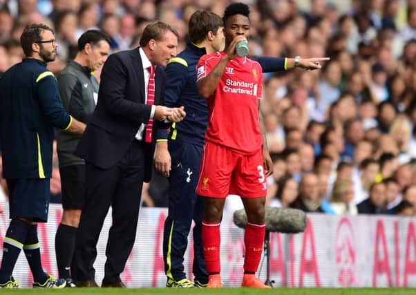 Liverpool manager Brendan Rodgers (left) gives advice to Raheem Sterling on the touchline during the Barclays Premier League match at White Hart Lane. Photo: Adam Davy/PA Wire.