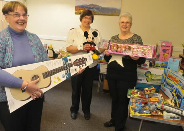 Christine Hunt, Lt Maisie Veacock and Janet Raven with a selection of toys donated for this years Toy Appeal.