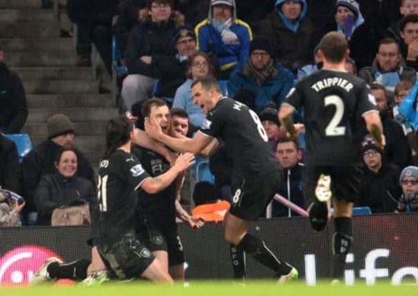 Burnley's Ashley Barnes (centre) celebrates scoring his side's second goal during the Barclays Premier League match at the Etihad Stadium. Photo: Martin Rickett/PA Wire.