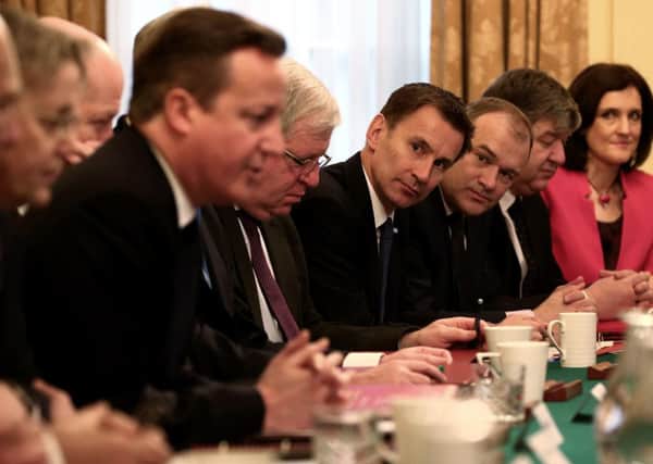 Prime Minister David Cameron (centre left) hosts a cabinet meeting as Health Secretary Jeremy Hunt (4th right) and Energy and Climate Secretary Ed Davey (3rd right) look on, at the first Cabinet meeting of 2015 at 10 Downing Street in London. PRESS ASSOCIATION Photo. Picture date: Tuesday January 6, 2015. Photo credit should read: Dan Kitwood/PA Wire