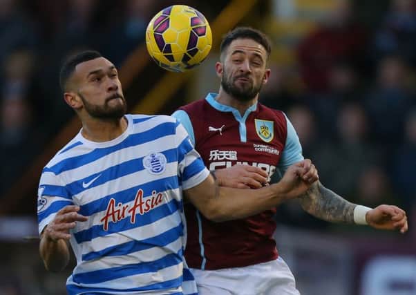 Danny Ings challenges for the ball with Steven Caulker