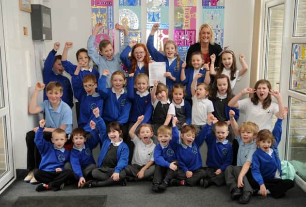 GOOD GRADES: Headteacher Jo Roberts with pupils at Saint Michaels and All Angels Primary School who are celebrating their latest Ofsted results