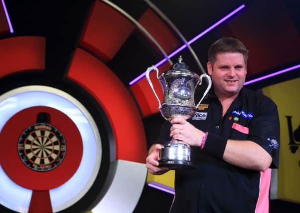Scott Mitchell celebrates with the trophy after defeating Martin Adams during the 2015 BDO Lakeside World Professional Darts Championships at the Lakeside Complex.