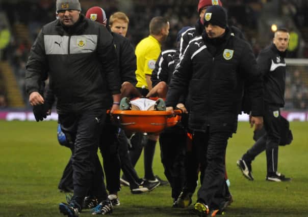 Stephen Ward is carried off the pitch.