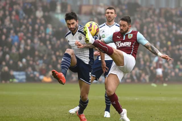Burnley's Danny Ings battles for the ball with West Bromwich Albion's Claudio Yacob, during the Barclays Premier League match at Turf Moor, Burnley. PRESS ASSOCIATION Photo. Picture date: Sunday February 8, 2015. See PA story SOCCER Burnley. Photo credit should read: Martin Rickett/PA Wire. RESTRICTIONS: Editorial use only. Maximum 45 images during a match. No video emulation or promotion as 'live'. No use in games, competitions, merchandise, betting or single club/player services. No use with unofficial audio, video, data, fixtures or club/league logos.