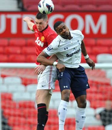 Manchester United's Michael Keane battles for the ball with Tottenham Hotspur's Jonathan Obika, during the Barclays Premier League Under 21 Final at Old Trafford, Manchester. PRESS ASSOCIATION Photo. Picture date: Monday May 20, 2013. See PA story SOCCER Final. Photo credit should read: Martin Rickett/PA Wire. RESTRICTIONS: Editorial use only. Maximum 45 images during a match. No video emulation or promotion as 'live'. No use in games, competitions, merchandise, betting or single club/player services. No use with unofficial audio, video, data, fixtures or club/league logos.