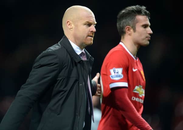 Burnley manager Sean Dyche walks off the pitch with Manchester United's Robin Van Persie (right) after the Barclays Premier League match at Old Trafford, Manchester. PRESS ASSOCIATION Photo. Picture date: Wednesday February 11, 2015. See PA story SOCCER Man Utd. Photo credit should read: Martin Rickett/PA Wire. RESTRICTIONS:  Editorial use only. Maximum 45 images during a match. No video emulation or promotion as 'live'. No use in games, competitions, merchandise, betting or single club/player services. No use with unofficial audio, video, data, fixtures or club/league logos.