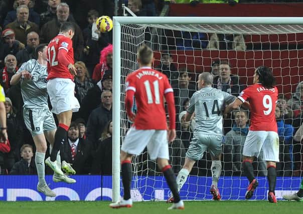 Chris Smalling climbs above Michael Keane to head his and Manchester Uniteds second goal