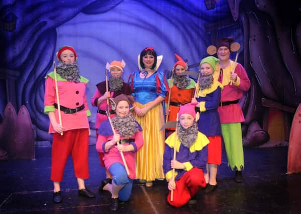 Louise Young as Snow White with the seven dwarfs in the Burnley Panto Society's production of Snow White and the Seven Dwarfs